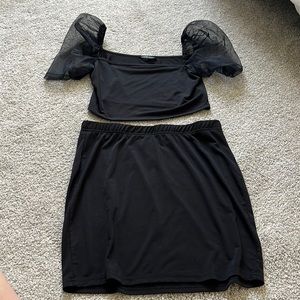 Black two piece set. Puffy, sheer sleeves. Crop top with skirt.